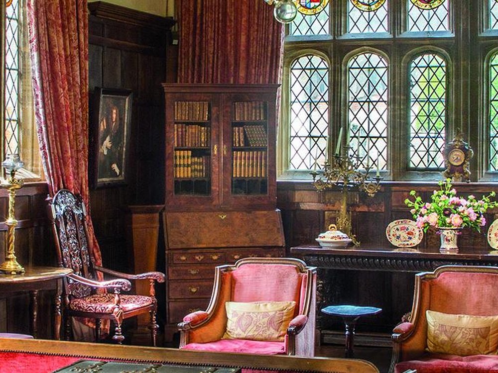 A panelled country-house interior with period furniture