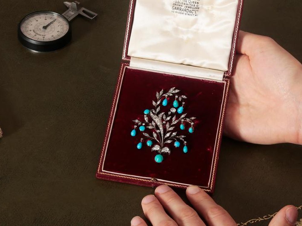 A specialist examining cased jewellery